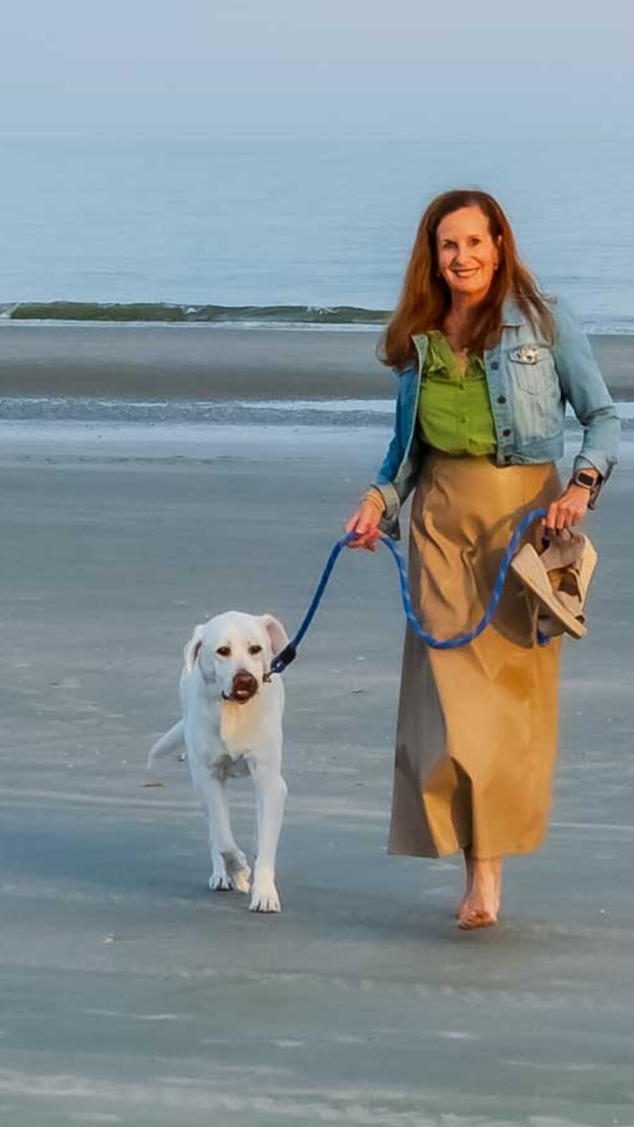Beth O'Connor walking with her Labrador Zoe on St. Simons Island beach