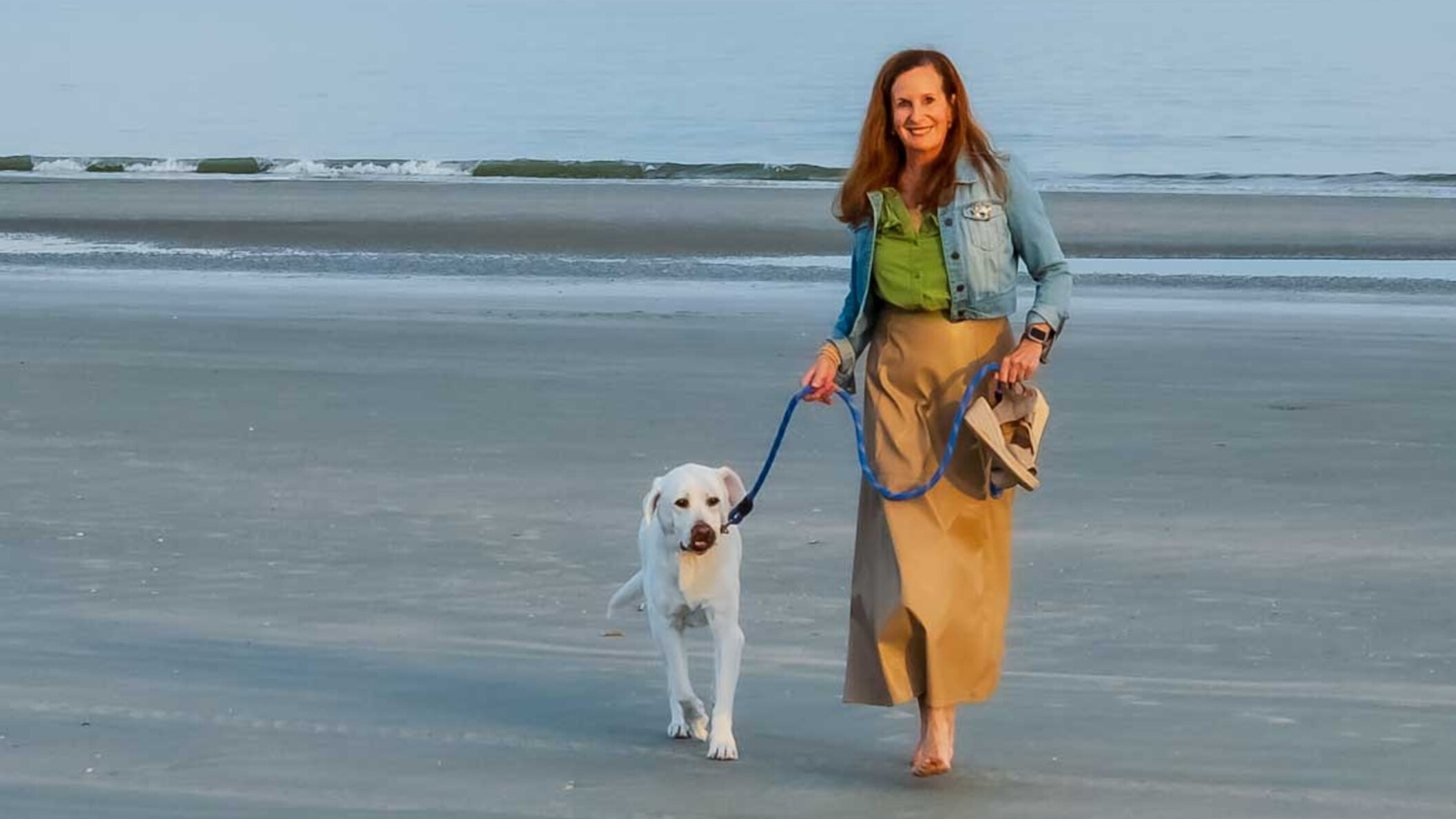 Beth O'Connor walking with her Labrador Zoe on St. Simons Island beach